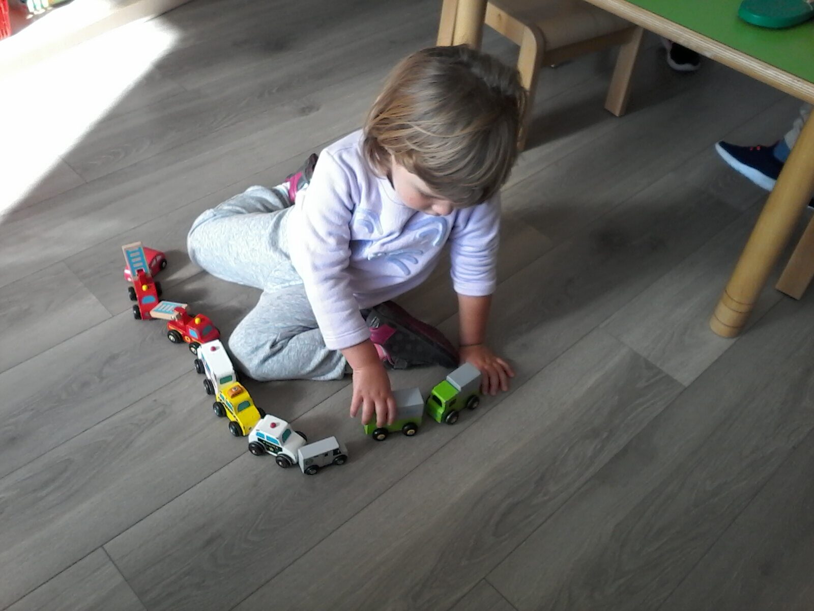 kids playing with vehicle toys